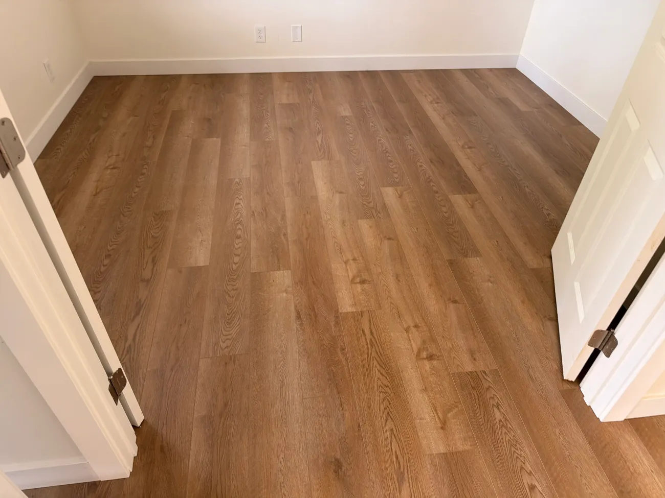 Samples of luxury vinyl plank and laminate flooring side by side in a North Carolina showroom