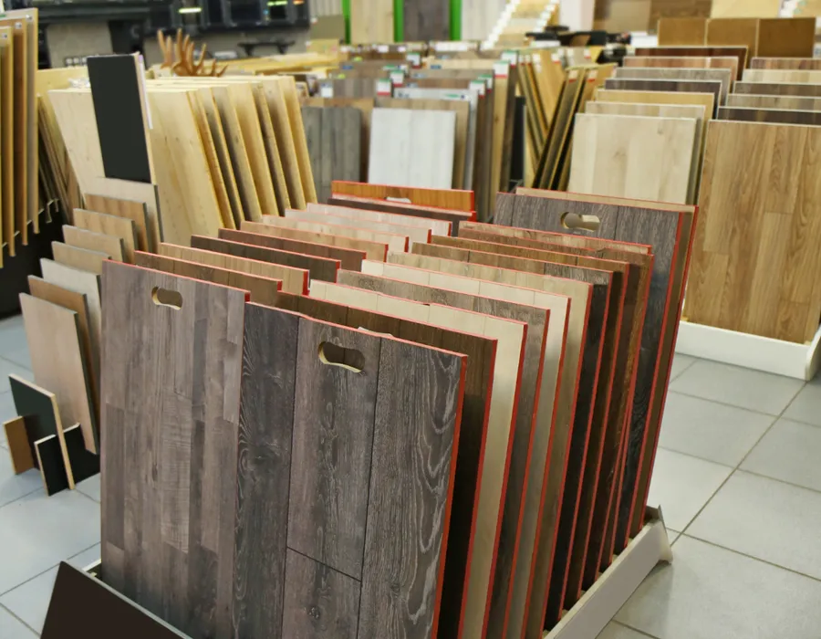 APW design consultant reviewing flooring samples with a couple